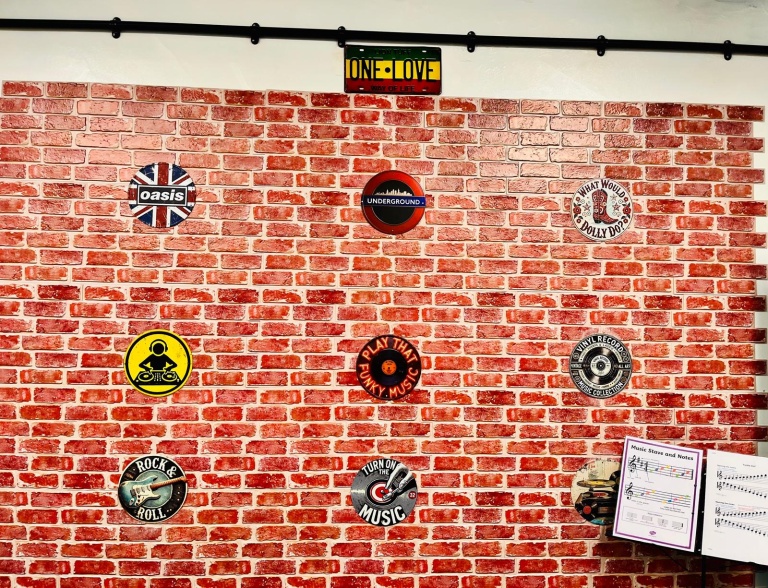 The music room brick feature wall with music signs